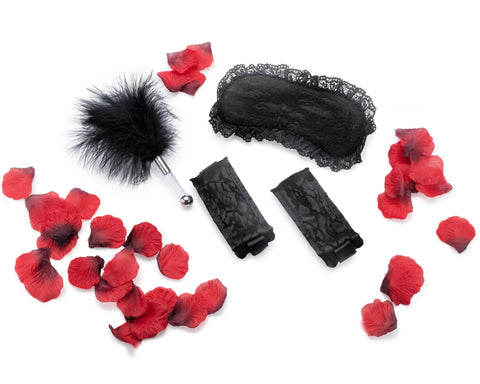Image of romantic anniversary gift set with lace mask and cuffs tickler and rose petals for romantic night