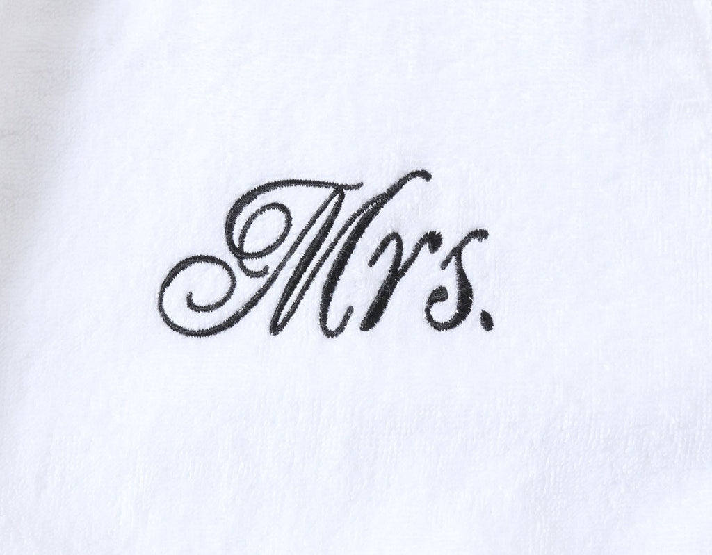Mrs stitching on couples matching Mr and Mrs bathrobes for wedding gifts