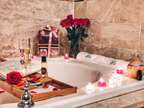 Image of his and hers hand towels romanic bath with romantic candles and rose petals