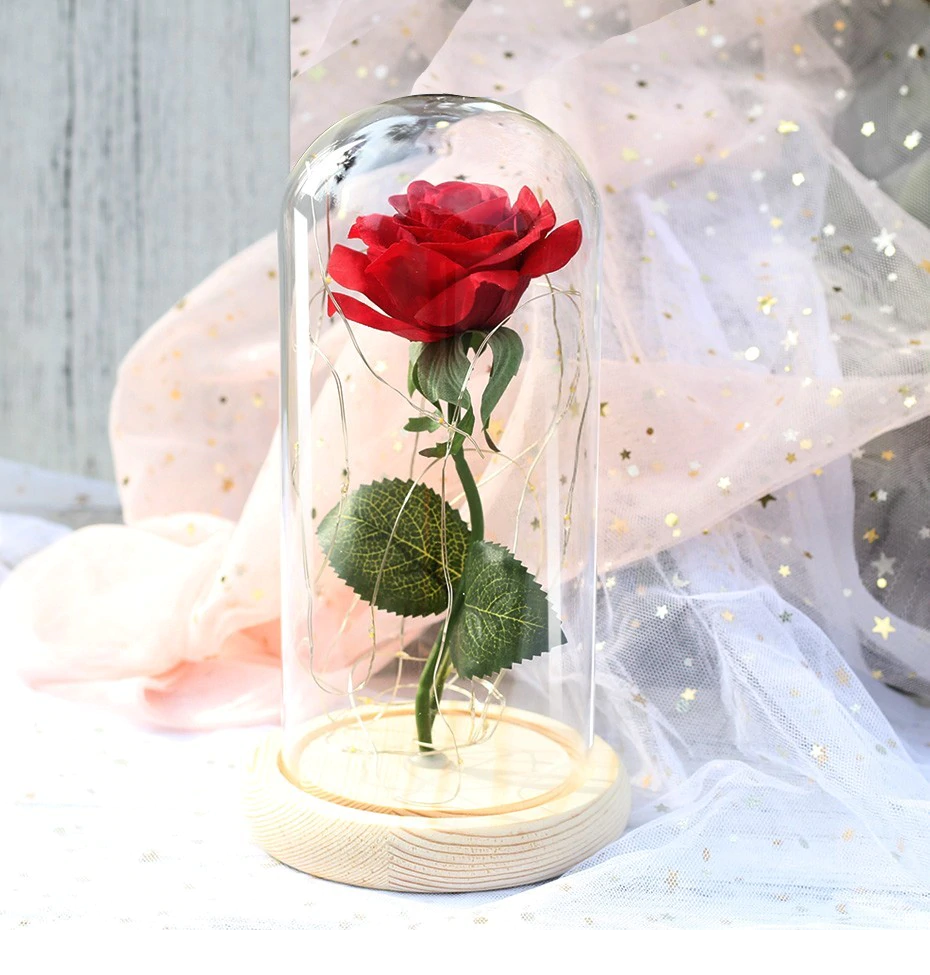 illuminated artificial rose in a glass dome